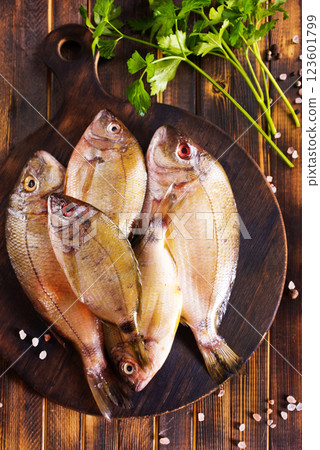 Uncooked Raw fish on board. wooden background. Uncooked Raw fish on board. wooden background. 123601799