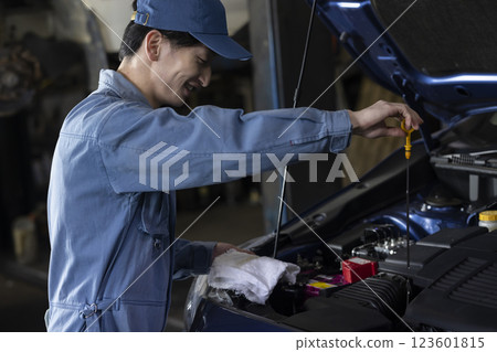 A man maintaining a car A man maintaining a car 123601815