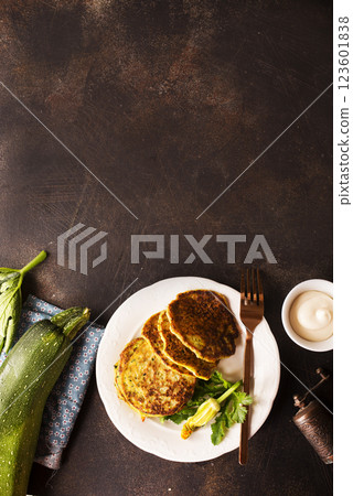 Potato pancakes with zucchini on white plate 123601838