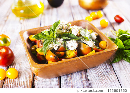 Greek salad with feta cheese and olives on wooden plate 123601860