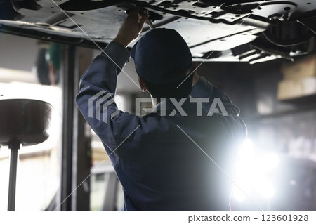 A man maintaining a car 123601928