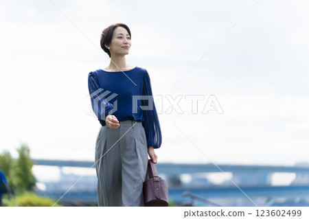Woman walking along the seaside path Woman walking along the seaside path 123602499