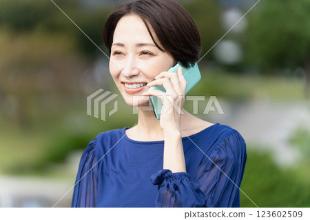 一名婦女在建築區打電話 一名婦女在建築區打電話 123602509