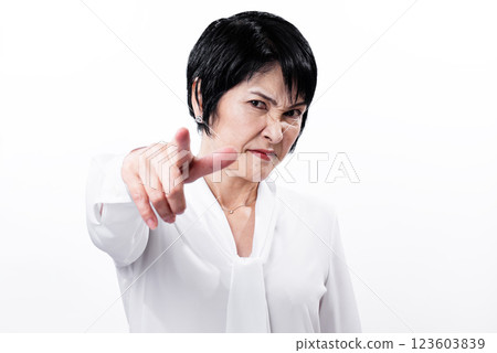 Aggressive middle-aged woman pointing with a frown 123603839