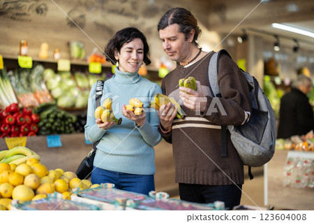 European couple standing near banana counter European couple standing near banana counter 123604008