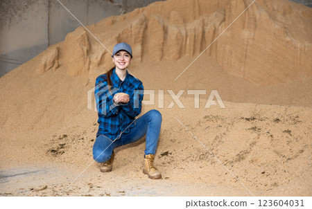 Farmer holding a handful of soybean husks in an animal feed warehouse Farmer holding a handful of soybean husks in an animal feed warehouse 123604031