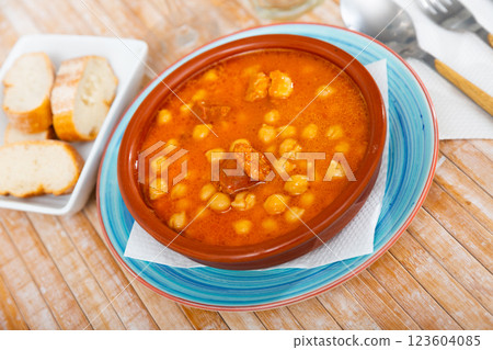 Chickpeas with chorizo served on plate in restaurant Chickpeas with chorizo served on plate in restaurant 123604085