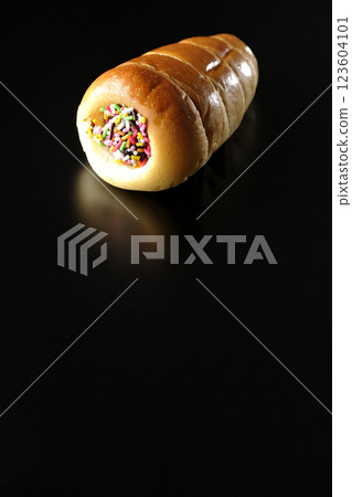 Chocolate cornet photographed alone against a black background Chocolate cornet photographed alone against a black background 123604101