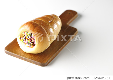 A chocolate cornet on a cutting board photographed alone on a white background 123604287