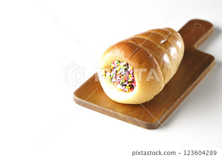 A chocolate cornet on a cutting board photographed alone on a white background 123604289