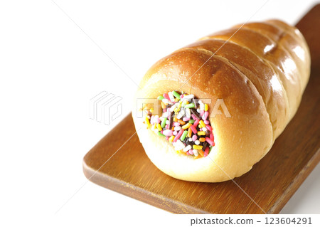 A chocolate cornet on a cutting board photographed alone on a white background 123604291
