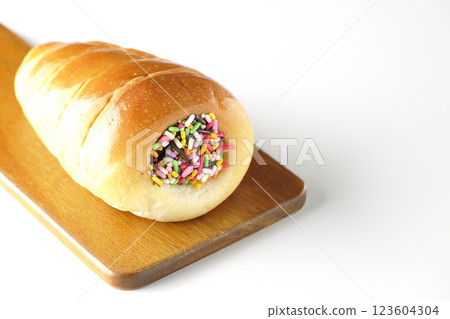 A chocolate cornet on a cutting board photographed alone on a white background 123604304
