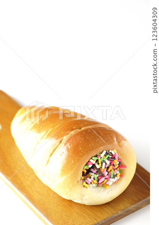 A chocolate cornet on a cutting board photographed alone on a white background 123604309