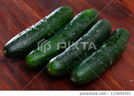 Many ripe cucumbers on wooden surface Many ripe cucumbers on wooden surface 123604391