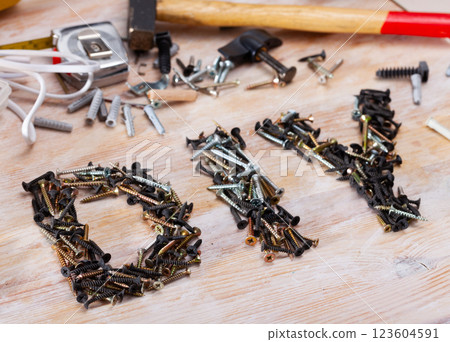 Word DIY lined with screws among fasteners and hand tools Word DIY lined with screws among fasteners and hand tools 123604591