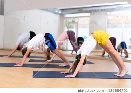 Family of four practicing yoga at gym 123604701