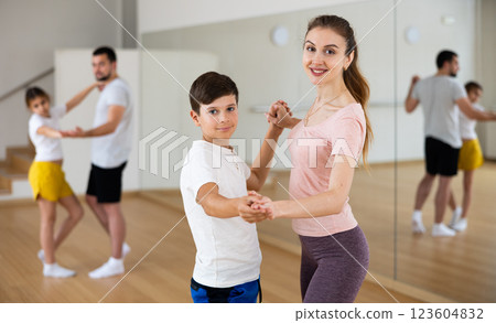 Mother dancing with her son during group family training 123604832