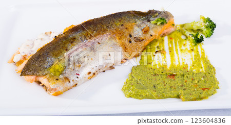 Tasty steak of fried river trout fillet with sause tartar on plate 123604836