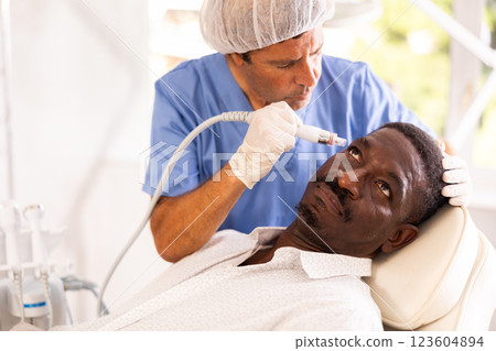 Specialist administers cosmetic treatment 123604894