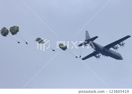 Ranger descending from a transport plane, airborne drop, parachute training, special forces Ranger descending from a transport plane, airborne drop, parachute training, special forces 123605419