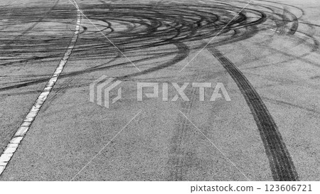 Black tire marks on asphalt road race track, Car tire track asphalt road texture and background, Abstract asphalt road background of tires tracks, Black tyre mark on asphalt road. Black tire marks on asphalt road race track, Car tire track asphalt road texture and background, Abstract asphalt road background of tires tracks, Black tyre mark on asphalt road. 123606721