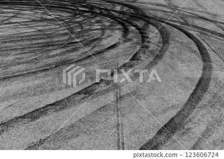 Black tire marks on asphalt road race track, Car tire track asphalt road texture and background, Abstract asphalt road background of tires tracks, Black tyre mark on asphalt road. Black tire marks on asphalt road race track, Car tire track asphalt road texture and background, Abstract asphalt road background of tires tracks, Black tyre mark on asphalt road. 123606724