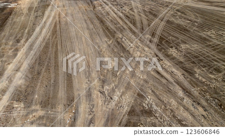 Tyre track on dirt sand or mud off road track, Tire mark ground vehicle wheel shape, Dirt soil texture, Top view tires tracks on dry mud background and texture. 123606846