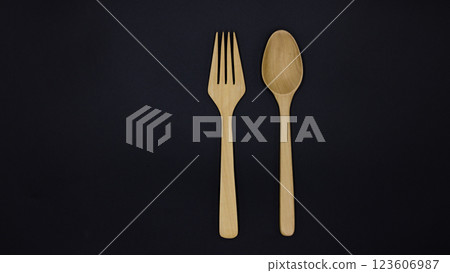 Wooden spoon and fork on black background, One set of wood spoon and fork kitchen ware, Eco friendly Wooden fork and spoon, Top view 123606987