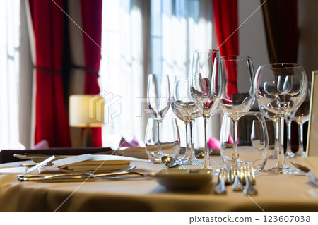 Wine glasses and cutlery on the table - Table setting for a course meal Wine glasses and cutlery on the table - Table setting for a course meal 123607038