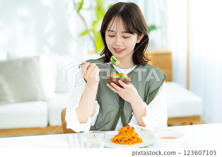A young woman eating a salad A young woman eating a salad 123607105