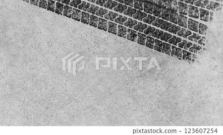 Black tire marks on road, Black rubber tire marks and tread marks, Tire trace track wheels texture and background, Auto tire tread grunge, Car wheel tyre tread track black tyre print, Top view. 123607254