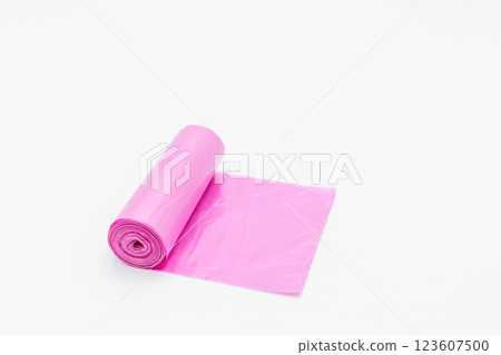 Roll of pink plastic garbage bags on white background, Pink color garbage bags roll,  Roll of pink plastic garbage bags on white background. 123607500