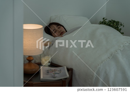 A young woman sleeping in bed A young woman sleeping in bed 123607591