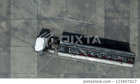 Fuel truck park on parking lot, Business oil and gas transportation and logistics with petrochemicals liquid chemical freight, Fuel tank truck transports fuel, Aerial view. Fuel truck park on parking lot, Business oil and gas transportation and logistics with petrochemicals liquid chemical freight, Fuel tank truck transports fuel, Aerial view. 123607827