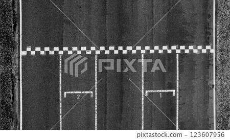 Start or finish line on car race, Start and finish line racing, Grid start race track, Top view textured and background grid start on the asphalt road race track abstract. Start or finish line on car race, Start and finish line racing, Grid start race track, Top view textured and background grid start on the asphalt road race track abstract. 123607956