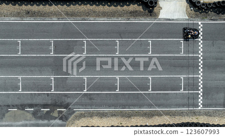 Aerial view Go kart racer cross the finish line, Go kart at circuit start and finish line, Top view race go kart track. Aerial view Go kart racer cross the finish line, Go kart at circuit start and finish line, Top view race go kart track. 123607993