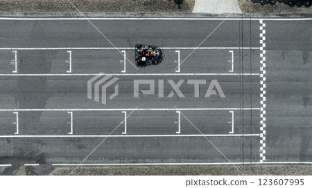 Aerial view Go kart racer cross the finish line, Go kart at circuit start and finish line, Top view race go kart track. Aerial view Go kart racer cross the finish line, Go kart at circuit start and finish line, Top view race go kart track. 123607995