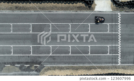 Aerial view Go kart racer cross the finish line, Go kart at circuit start and finish line, Top view race go kart track. Aerial view Go kart racer cross the finish line, Go kart at circuit start and finish line, Top view race go kart track. 123607996