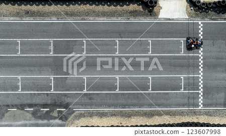 Aerial view Go kart racer cross the finish line, Go kart at circuit start and finish line, Top view race go kart track. 123607998