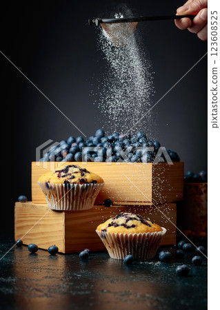Blueberry muffins and berries in a wooden box. 123608525