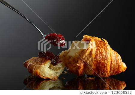 Fresh baked croissant with butter and raspberry jam. 123608532