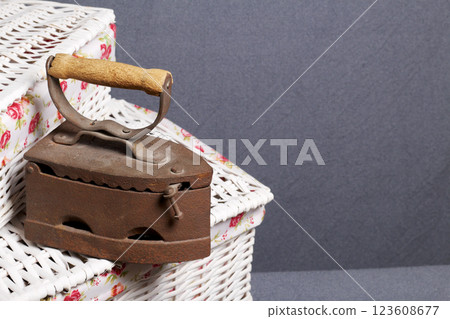 Old iron, heated by hot coals. Located on a wicker baskets. 123608677