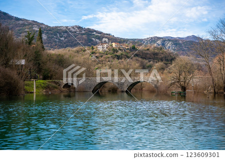 Arched bridge over Crnojevic river in small town near Skadar lake in Montenegro in winter time 123609301