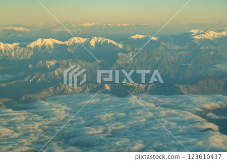 The Japanese Alps in the morning sun as seen from an airplane The Japanese Alps in the morning sun as seen from an airplane 123610437