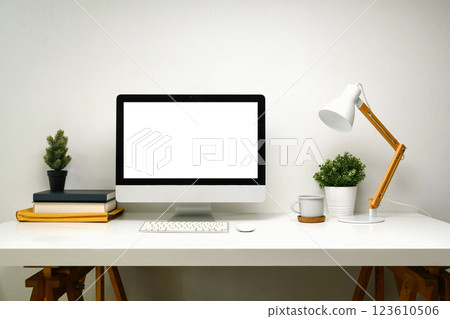 Modern minimalist workspace featuring desktop computer with blank screen on a clean desk. 123610506