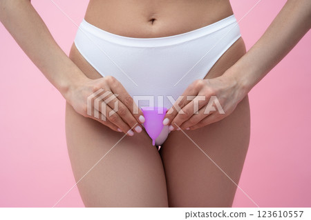 Unrecognizable girl holding menstrual cup alternative protection during period Unrecognizable girl holding menstrual cup alternative protection during period 123610557