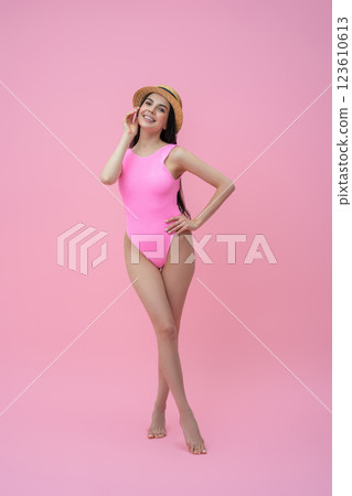 Enjoyed pretty young woman in pink bodysuit and straw hat Enjoyed pretty young woman in pink bodysuit and straw hat 123610613