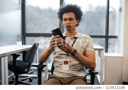 Lazy man having fun in workplace with pencil and making selfie in office Lazy man having fun in workplace with pencil and making selfie in office 123611106