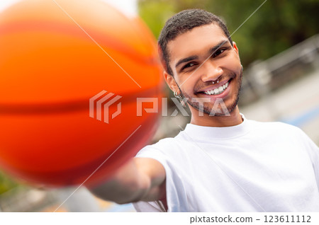 Waist up of a young dark-haired man with a ball Waist up of a young dark-haired man with a ball 123611112