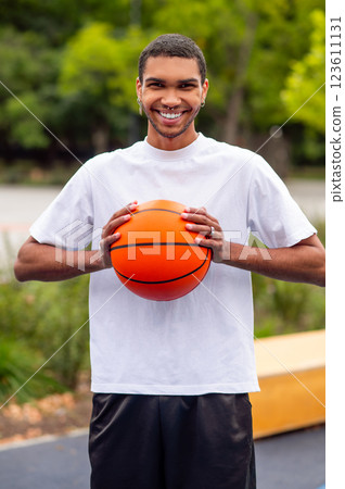 Man in a white tshirt and black shorts with a ball in hands Man in a white tshirt and black shorts with a ball in hands 123611131